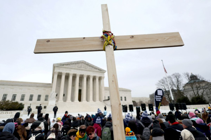 Anti-abortion activists hold a cross in front of the U.S. Supreme Court building during the annual "March for Life" in Washington, U.S., January 21, 2022. 