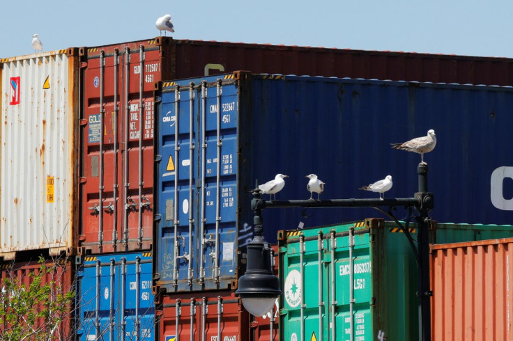 Sea gulls sit on a lamppost beside shipping containers stacked at the Paul W. Conley Container Terminal in Boston, Massachusetts, U.S., May 9, 2018.   