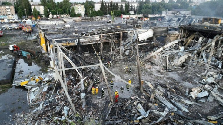 A handout picture taken and released by the Ukraine's State Emergency Service on June 28, 2022 shows rescuers working in the wreckage of a mall in the central city of Kremenchuk that was hit by a Russian missile