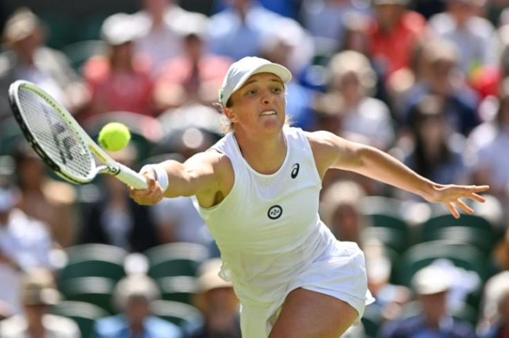 Top seed Iga Swiatek in action against Croatia's Jana Fett at Wimbledon