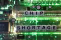 Plastic letters arranged to read "Chip Shortage" are placed on a computer motherboard in this illustration taken, February 20, 2022. 