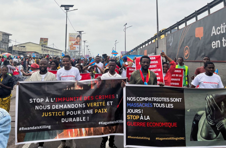Civil society members hold banners during an anti-Rwanda protest, amid tensions between Kinshasa and Kigali over Rwanda's suspected backing of the M23 rebel group, in Kinshasa, Democratic Republic of Congo June 25, 2022. 