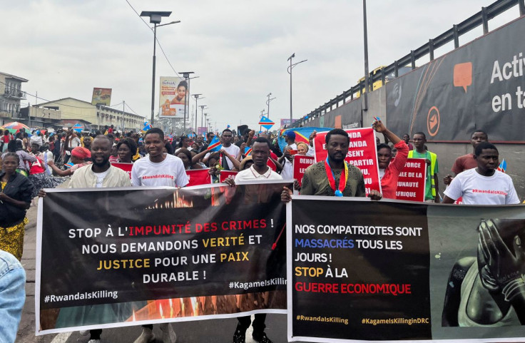 Civil society members hold banners during an anti-Rwanda protest, amid tensions between Kinshasa and Kigali over Rwanda's suspected backing of the M23 rebel group, in Kinshasa, Democratic Republic of Congo June 25, 2022.