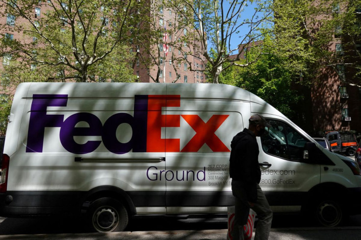 A person walks by a FedEx van in Manhattan, New York City, U.S., May 9, 2022. 