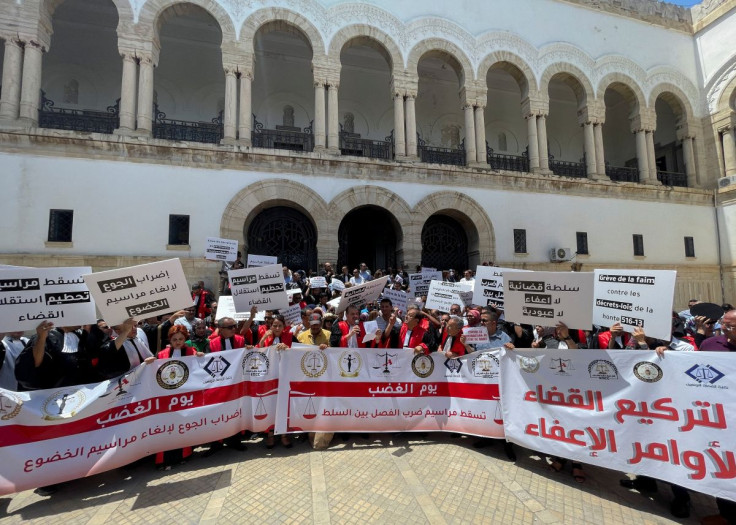 Tunisian judges carry banners during a protest against a decision by President Kais Saied to sack many of them, in Tunis, Tunisia June 23, 2022. Picture taken June 23, 2022. 