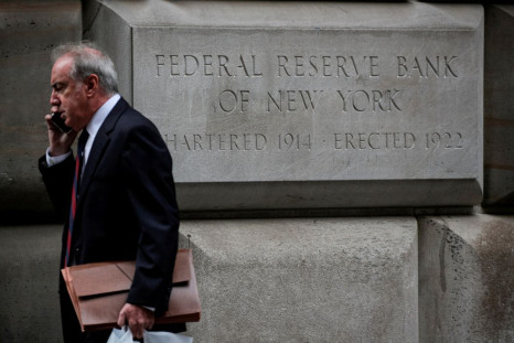 A man walks outside The Federal Reserve Bank of New York in New York City, U.S., October 12, 2021.  