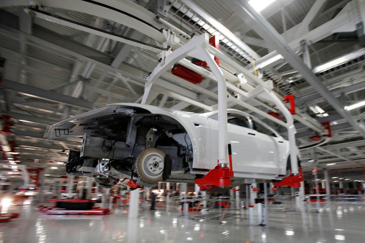 The body of  a Tesla Model S is transported by an automated crane at the Tesla factory in Fremont, California October 1, 2011. 