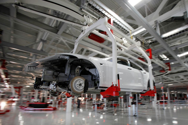 The body of a Tesla Model S is transported by an automated crane at the Tesla factory in Fremont, California October 1, 2011.