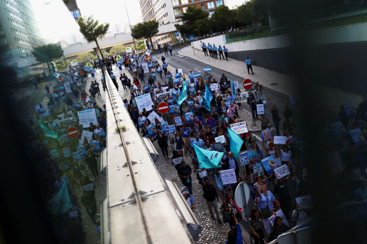Activists take part in the 'Blue Climate March' outside the UN Ocean Conference in Lisbon to urge world leaders to act and protect the environment, in Lisbon, Portugal, June 29, 2022. 