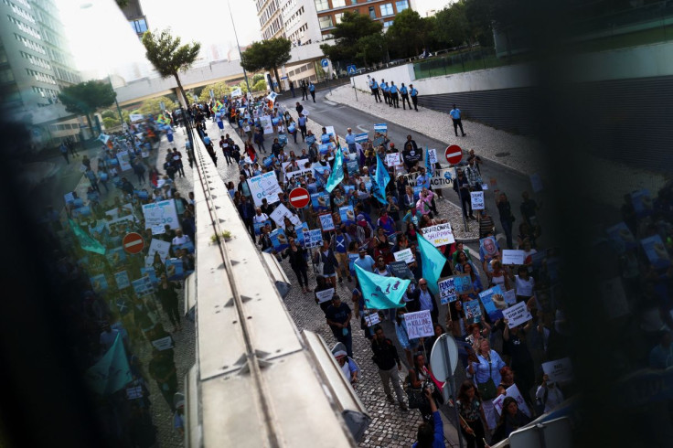 Activists take part in the 'Blue Climate March' outside the UN Ocean Conference in Lisbon to urge world leaders to act and protect the environment, in Lisbon, Portugal, June 29, 2022.