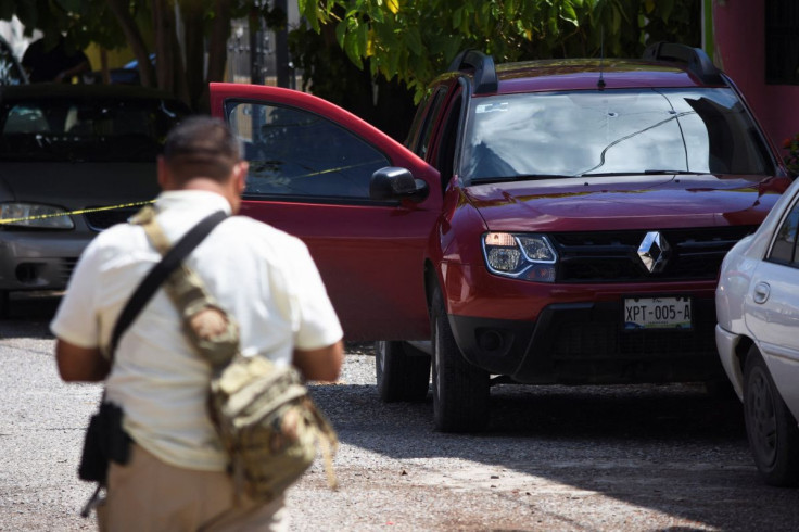 A police officer stands near the vehicle of journalist Antonio de la Cruz, who was killed by unknown assailants while leaving his home, in Ciudad Victoria, in Tamaulipas state, Mexico June 29, 2022.