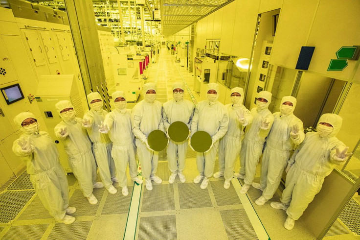 Samsung Electronics workers stand with wafers at its chip contract manufacturing facilities in Hwaseong, South Korea, in this handout image acquired by Reuters on June 30, 2022. Samsung Electronics/Handout via REUTERS
