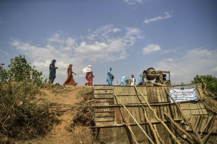 Volunteers from Jal Saheli âFriends of waterâ help to build a check dam on dried up Bachedi stream in Agrotha