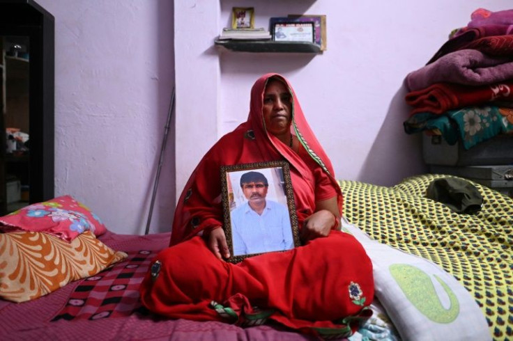 Jashoda Sahu Teli holds a picture of her slain husband Hindu tailor Kanhaiya Lal, who was allegedly killed by two Muslim men for supporting a former spokeswoman of the ruling Bharatiya Janata Party party for her remarks about the Prophet Mohammed