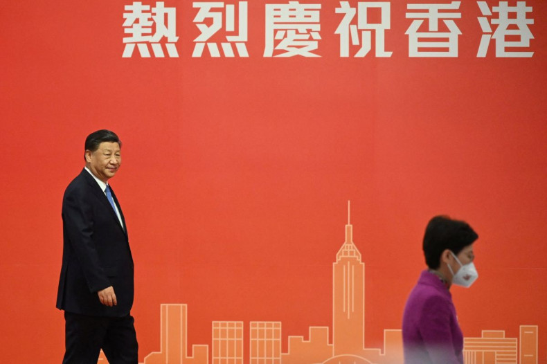 China's President Xi Jinping looks at Hong Kong's outgoing Chief Executive Carrie Lam as he prepares to speak on the podium following his arrival via high-speed rail, ahead of the 25th anniversary of the former British colony's handover to Chinese rule, i