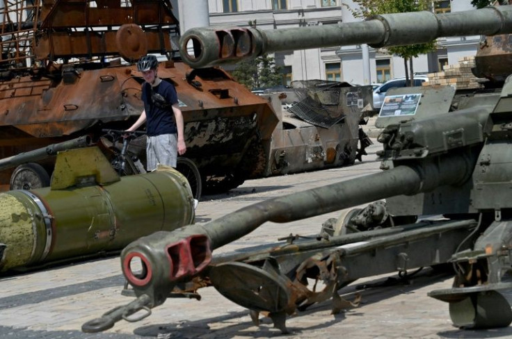 A man walks past destroyed Russian military equipment which are exhibited in the center of the Ukrainian capital Kyiv