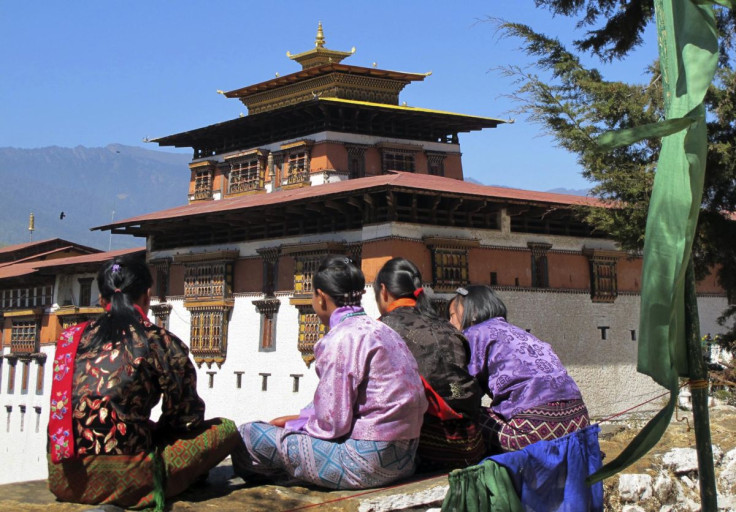 Bhutanese girls in traditional dress sit outside Rinpung Dzong in Paro Valley, Bhutan March 16, 2011.