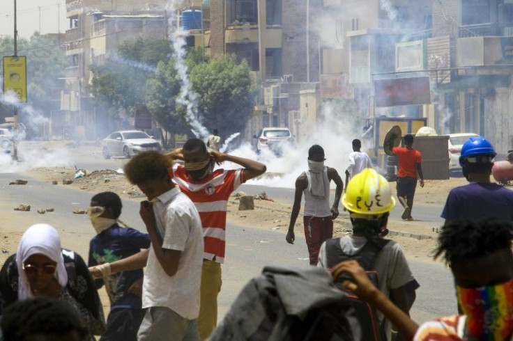 Sudanese demonstrators throw tear gas canisters back at security forces in the capital Khartoum on May 19, 2022, during a demonstration calling for civilian rule