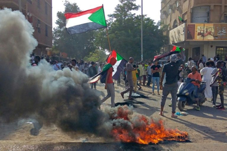 Sudanese protesters march towards the parliament building in Omdurman on April 6, 2022, during a rally against military rule