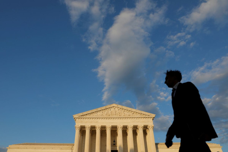 A person walks past the United States Supreme Court Building in Washington, D.C., U.S., May 13, 2021.