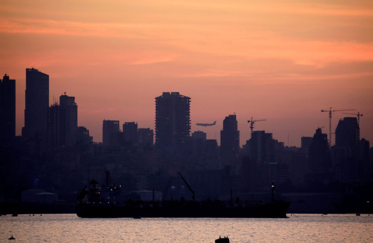 A plane flies as the skyline of Beirut is seen during sunset from Antelias, Lebanon November 20, 2019. 