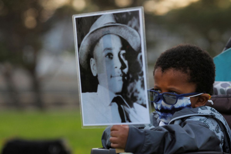 Four-year-old Senty Banutu-Gomez holds a photograph of Emmett Till, a 14-year-old Black boy who was lynched in 1955, at a vigil on the one year anniversary of the murder of George Floyd while in Minneapolis police custody, in Lynn, Massachusetts, U.S., Ma