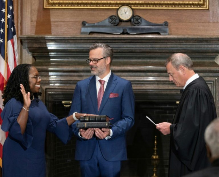 Chief Justice John G. Roberts administers the Constitutional Oath to Ketanji Brown Jackson, while her husband Patrick Jackson holds the Bible at the Supreme Court on June 30, 2022