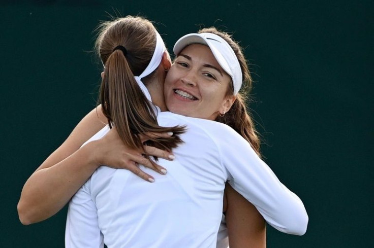All change: Russian-born Georgian player Natela Dzalamidze (right) hugs partner Aleksandra Krunic after winning their women's doubles match on Thursday