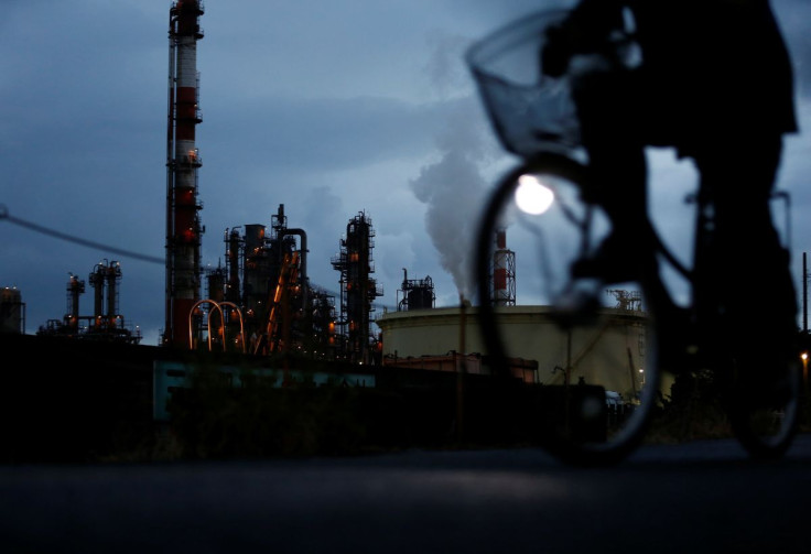 A bicycle rider rides past a factory at Keihin industrial zone in Kawasaki, south of Tokyo, Japan, August 18, 2016.  