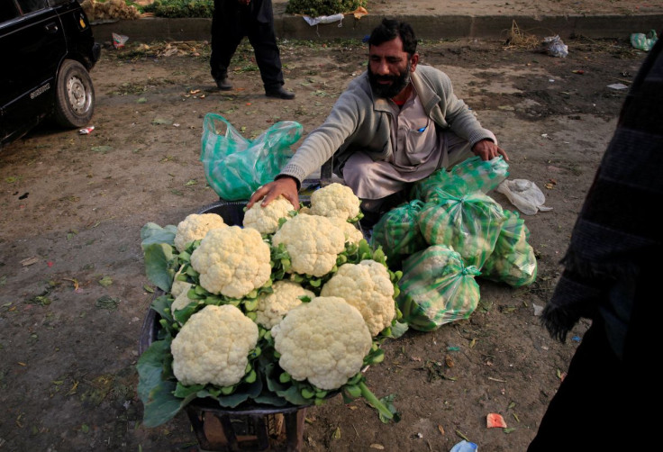A man arranges cauliflowers for sale on his wheelbarrow at a vegetable market in Islamabad, Pakistan January 29, 2018. 