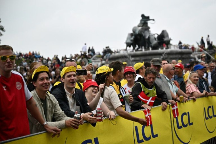 Spectators wave Danish flags along the race route