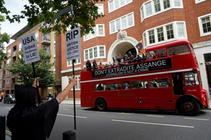 Protesters aboard a double-decker bus protested outside Britain's interior ministry against Assange's  extradition