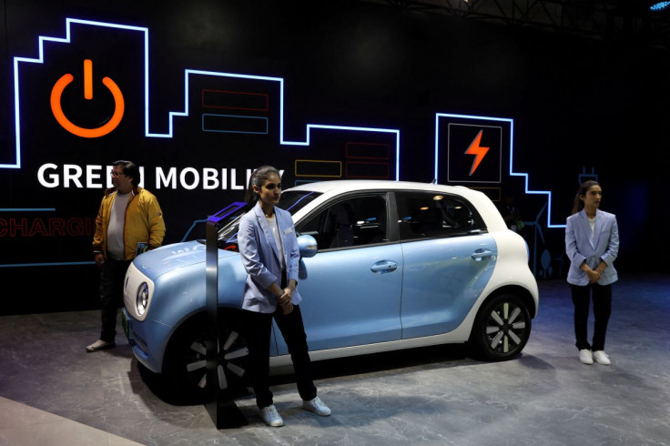 Models pose next to Great Wall Motors (GWM) GWM R1 electric car at its pavilion at the India Auto Expo 2020 in Greater Noida, India, February 5, 2020. 
