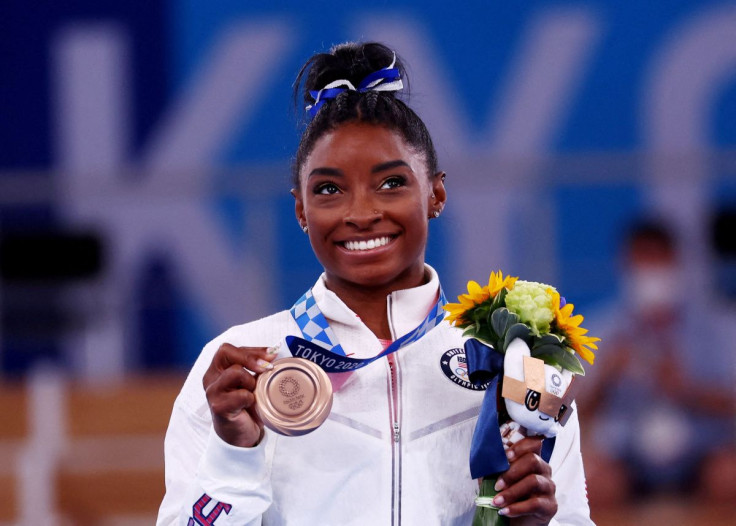Tokyo 2020 Olympics - Gymnastics - Artistic - Women's Beam - Medal Ceremony - Ariake Gymnastics Centre, Tokyo, Japan - August 3, 2021. Bronze medallist Simone Biles of the United States celebrates on the podium 