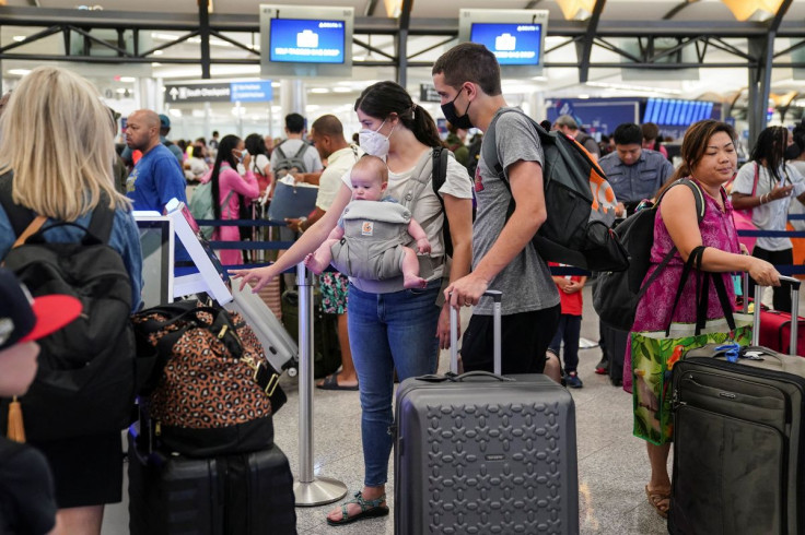 Passengers with a baby use a Delta Air Lines check-in kiosk at Hartsfield-Jackson Atlanta International Airport ahead of the Fourth of July holiday in Atlanta, Georgia, U.S., July 1, 2022.  
