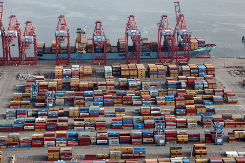 Shipping containers are unloaded from a ship at a container terminal at the Port of Long Beach-Port of Los Angeles complex, in Los Angeles, California, U.S., April 7, 2021. 
