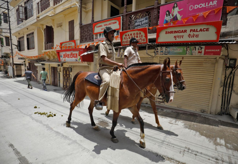 Policemen mounted on their horses patrol during restrictions imposed by authorities after the killing of Kanhaiya Lal Teli, a Hindu tailor, carried out by two suspected Muslim men who filmed the act and posted it online, in Udaipur in the northwestern sta