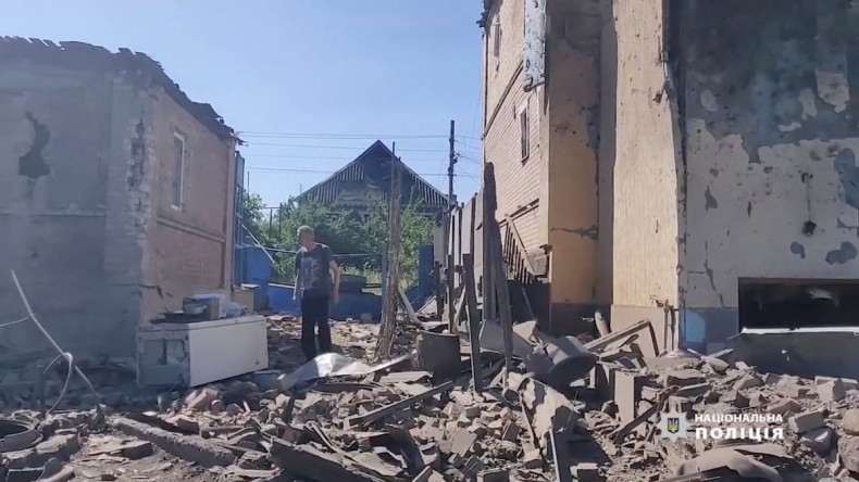 A man walks in the rubble near damaged buildings, as Russia's invasion of Ukraine continues, in Bakhmut, Donetsk Oblast, Ukraine in this still image obtained from a social media video released on July 2, 2022. National Police of Ukraine/Handout via REUTER