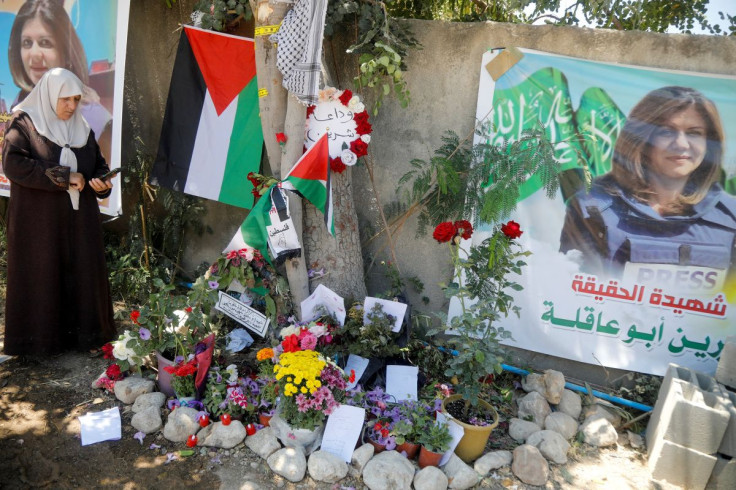 A Palestinian woman takes pictures at the scene where Al Jazeera reporter Shireen Abu Akleh was shot dead during an Israeli raid, in Jenin, in the Israeli-occupied West Bank, May 17, 2022. Picture taken May 17, 2022. 