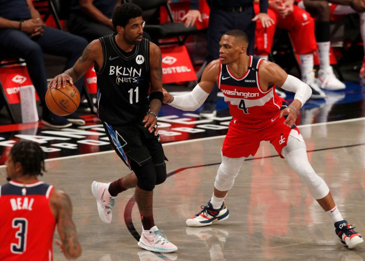 Kyrie Irving #11 of the Brooklyn Nets in action against Russell Westbrook #4 of the Washington Wizards