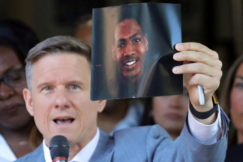 Attorney Bobby DiCello holds up a photograph of Jayland Walker, the man who was shot dead by Akron Police on June 25, as he speaks on behalf of the Walker family during a press conference at St. Ashworth Temple in Akron, Ohio, U.S. June 30, 2022.  Jeff La