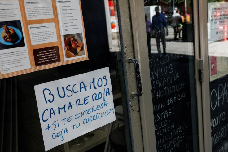 A sign that reads "Waiter needed. If interested, drop CV"  is posted on the window of a restaurant in central Madrid, Spain, May 31, 2022. Picture taken May 31, 2022. 