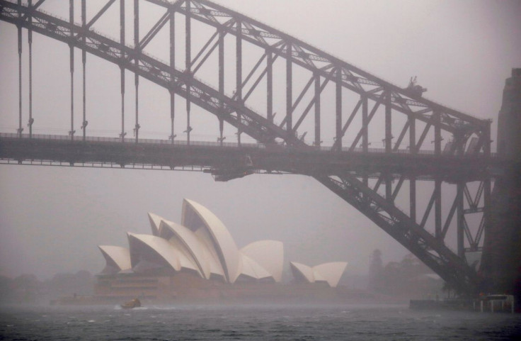 A boat passes under the Sydney Harbour Bridge and in front of the Sydney Opera House as strong winds and heavy rain hit the city of Sydney, Australia, November 28, 2018. 