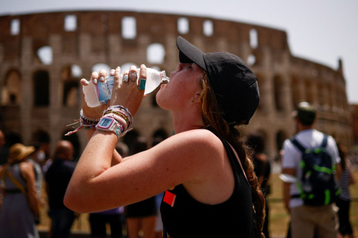 A girl drinks water near the Colosseum as an extraordinary heatwave hits Italy, in Rome, June 27, 2022.