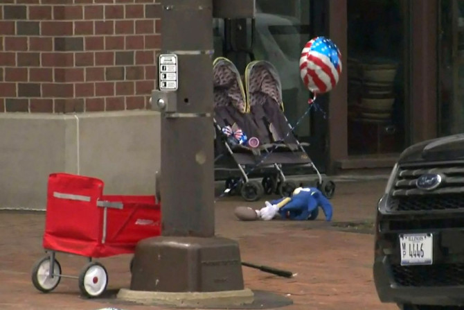 A child's stroller with a stars and stripes balloon attached is left after gunfire erupted at a Fourth of July parade route in the wealthy Chicago suburb of Highland Park, Illinois, U.S. July 4, 2022 in a still image from video. ABC affiliate WLS/ABC7 via