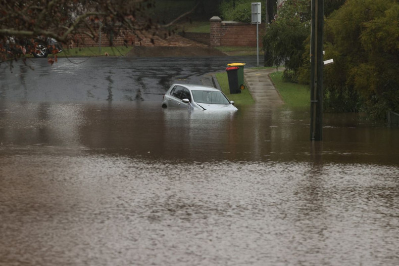 A vehicle is submerged by floodwaters in a residential area following heavy rains in the Windsor suburb of Sydney, Australia, July 5, 2022.  