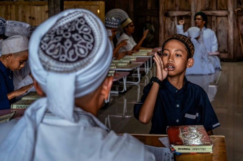 A student at the boarding school recites the Koran using sign language
