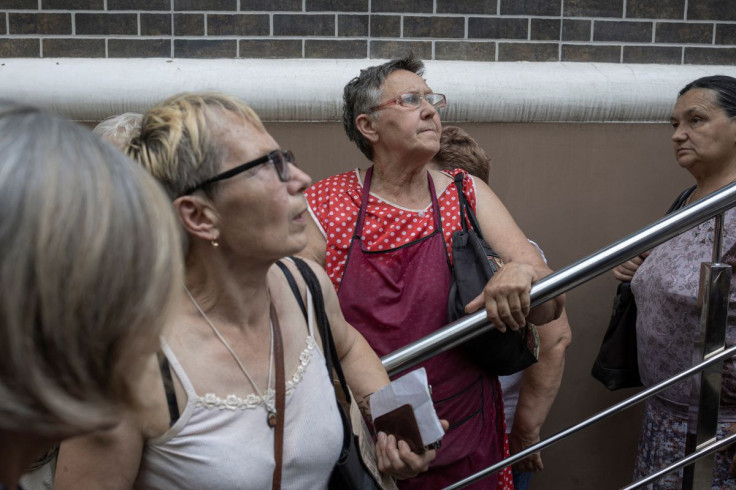 People wait to receive humanitarian aid as Russia's attack on Ukraine continues, in Kramatorsk, Donetsk region, Ukraine, July 4, 2022.