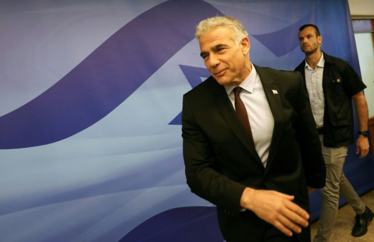 Israel's Prime Minister Yair Lapid arrives to attend the first cabinet meeting in Jerusalem on July 3: on Tuesday, Lapid is in Paris on his first foreign trip as premier