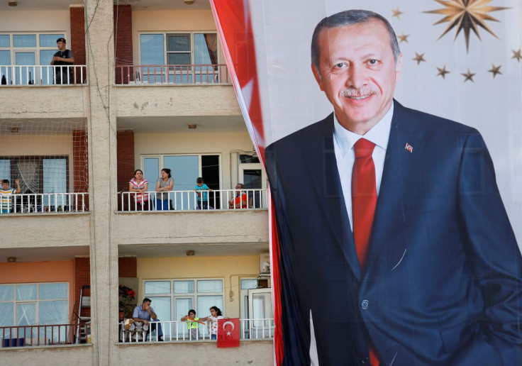 People watch an election rally of Turkish President Tayyip Erdogan from a building in Mardin, capital of Mardin province in southeastern Turkey, June 20, 2018.